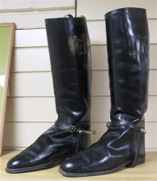 A pair of black leather riding boots and trees